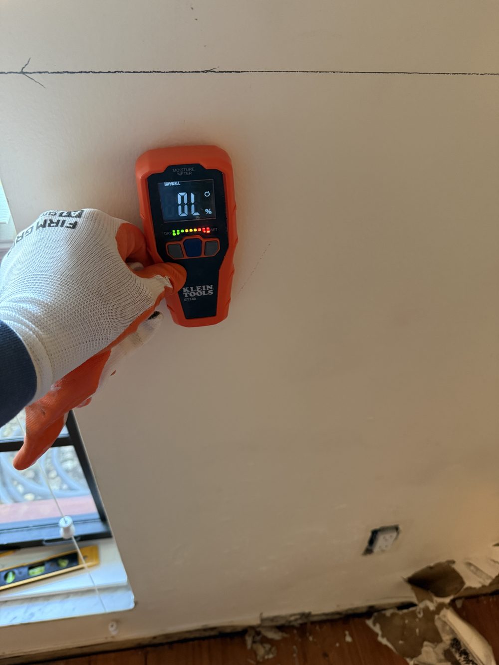 Moisture meter detecting elevated moisture in a wall
